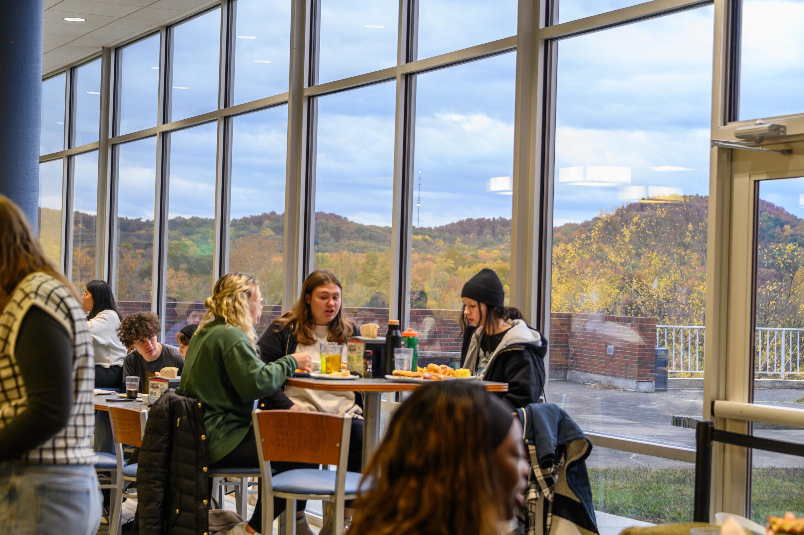 Berea College students seated around a table in the Mountaineer Dining Hall.