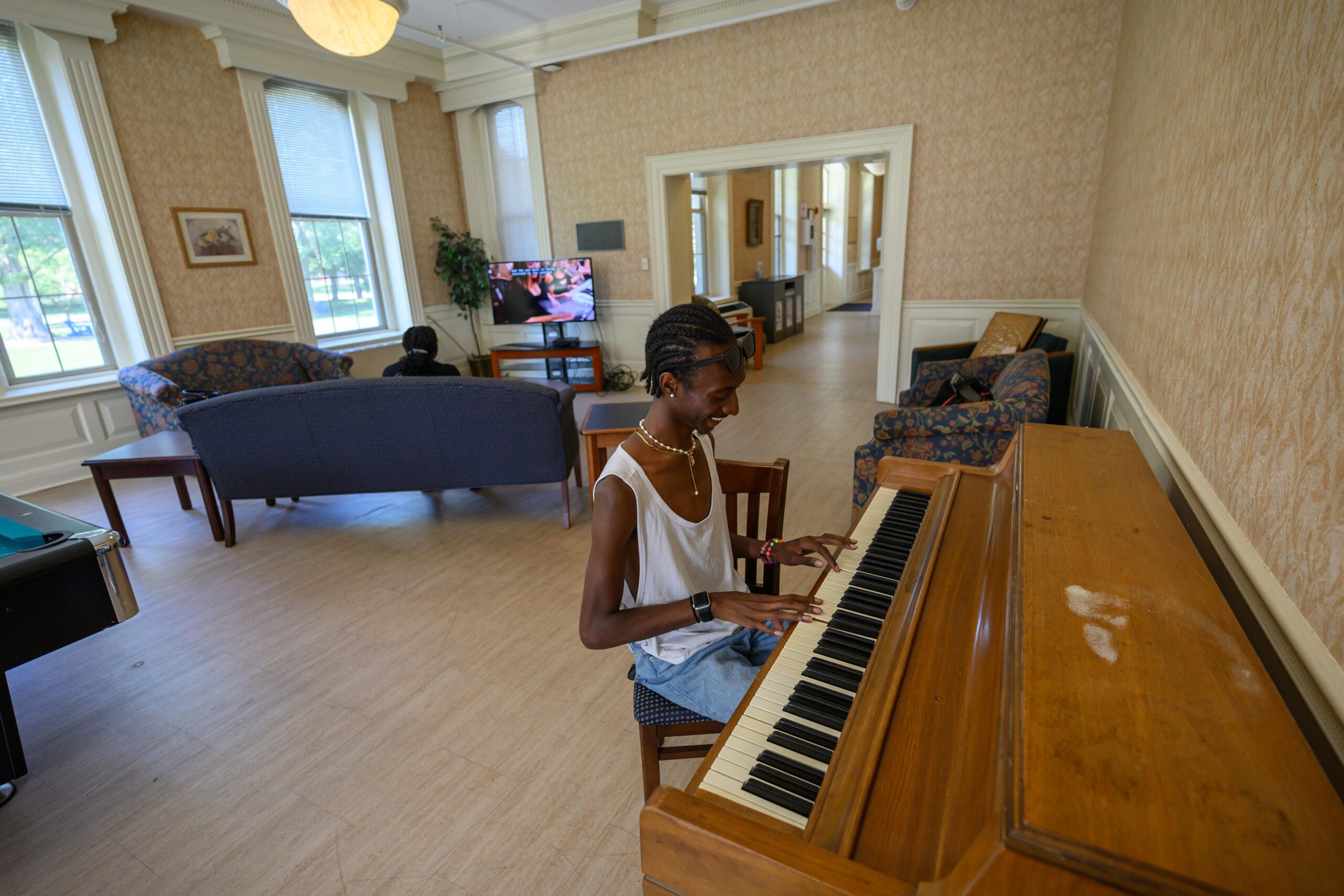 Student playing the piano in Fairchild Residence Hall at Berea College