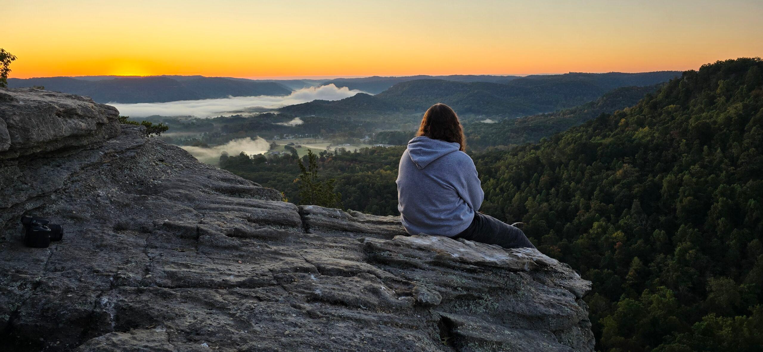 One student sits on the East Pinnacle, overlooking the sunrise.