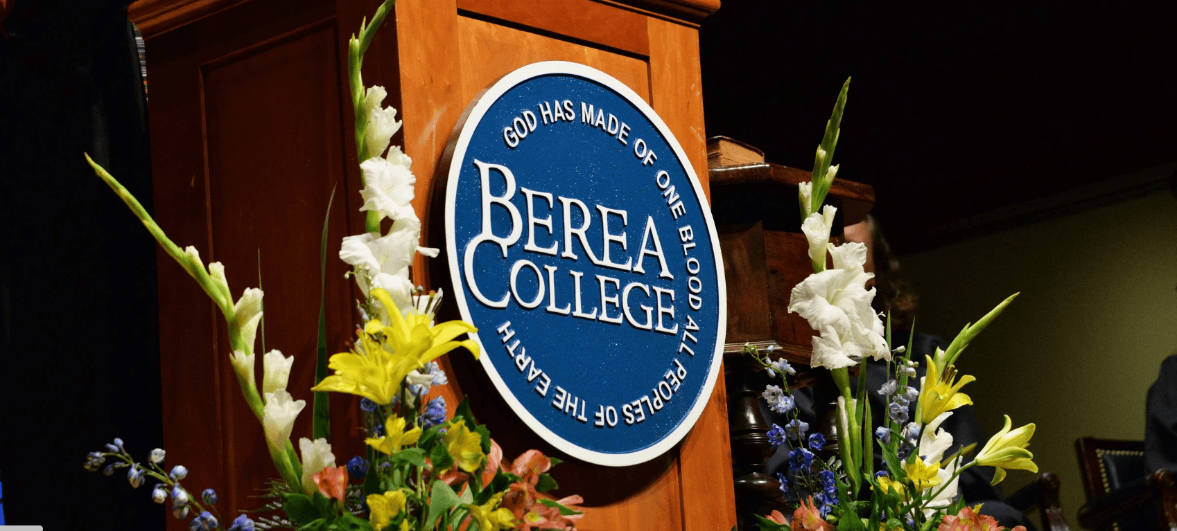 berea college podium with logo and surrounded with flowers