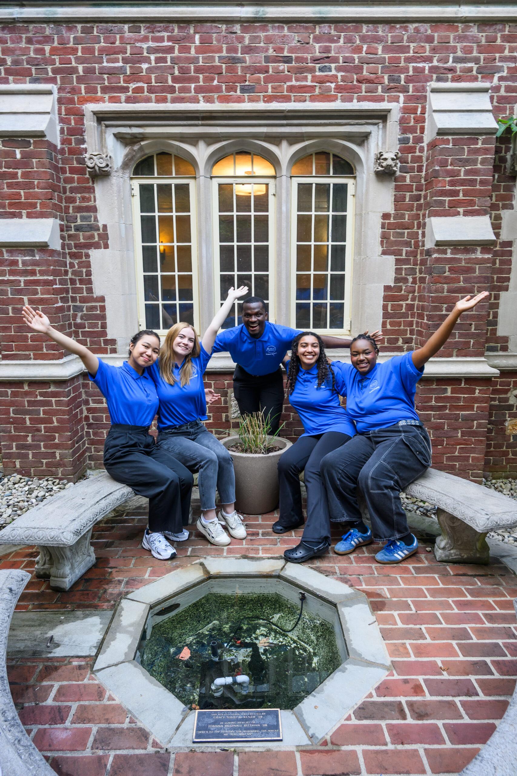 Students chaplains sharing a group hug smiling towards the camera
